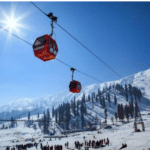 View of cable cars across Gulmarg’s sunlight snow capped mountains