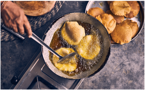 Poori in a pan with oil