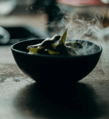 Sweet peas in a bowl with steam coming out