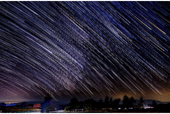 rain of stars with a city in the background