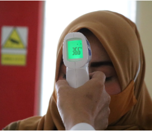 Woman getting her temperature checked