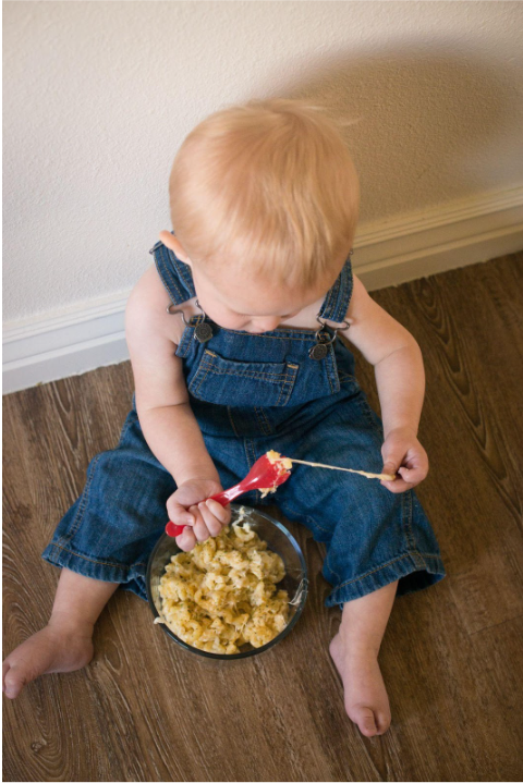 A Kid eating mac and cheese