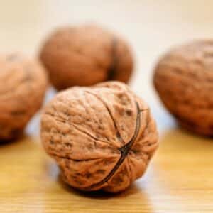 four brown-coloured walnuts on the table