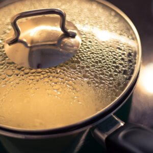 In a covered saucepan, rice is cooking beverage